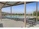 An exterior view of a community pool with lounge chairs and picnic tables at 595 Beverly Pine Pl, Henderson, NV 89011