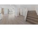 Bright foyer with durable flooring, staircase, and adjacent to a spacious living room at 595 Beverly Pine Pl, Henderson, NV 89011