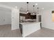 Well-lit kitchen with modern island, stainless appliances, and ample cabinet space at 595 Beverly Pine Pl, Henderson, NV 89011