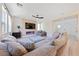 Bright and spacious living room featuring large sectional, modern fireplace, and natural light at 595 Beverly Pine Pl, Henderson, NV 89011