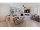 Cozy living room featuring contemporary fireplace, ceiling fan, and lots of natural light at 595 Beverly Pine Pl, Henderson, NV 89011