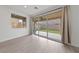 Living room with sliding glass doors leading to backyard patio and light colored laminate flooring at 595 Beverly Pine Pl, Henderson, NV 89011