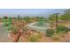 A spacious playground featuring an assortment of equipment amid trees and landscaping at 595 Beverly Pine Pl, Henderson, NV 89011