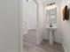 Stylish powder room features a pedestal sink, decorative mirror, and modern lighting at 595 Beverly Pine Pl, Henderson, NV 89011