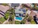 Aerial view of a two-story home featuring a backyard pool, solar panels, palm trees, and basketball court at 7141 Groveton Ct, Las Vegas, NV 89131