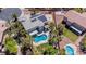 Aerial view showcasing a home with a pool, basketball court, solar panels, and lush greenery at 7141 Groveton Ct, Las Vegas, NV 89131