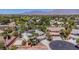 Overhead view of a two-story home with solar panels surrounded by mature palm trees and desert landscaping at 7141 Groveton Ct, Las Vegas, NV 89131