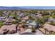 Aerial view of a community home with desert landscaping, solar panels, and neighborhood mountain views at 7141 Groveton Ct, Las Vegas, NV 89131