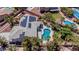 Aerial view of a home with solar panels, a swimming pool, and beautifully landscaped grounds at 7141 Groveton Ct, Las Vegas, NV 89131