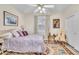 Cozy bedroom with a comfortable bed, colorful accents, and a ceiling fan for a restful ambiance at 7141 Groveton Ct, Las Vegas, NV 89131