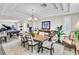 Elegant dining room with a tray ceiling, chandelier, and adjacent game area with a pool table and piano at 7141 Groveton Ct, Las Vegas, NV 89131