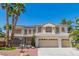 Attractive two-story home featuring a three-car garage, desert landscaping and solar panels on the roof at 7141 Groveton Ct, Las Vegas, NV 89131