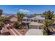 Gorgeous two-story home featuring a three-car garage, desert landscaping and solar panels on the roof at 7141 Groveton Ct, Las Vegas, NV 89131