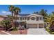 Charming two-story home featuring a three-car garage, desert landscaping and solar panels on the roof at 7141 Groveton Ct, Las Vegas, NV 89131