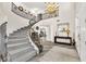 Dramatic foyer showcasing the staircase, high ceilings, elegant chandelier and herringbone flooring at 7141 Groveton Ct, Las Vegas, NV 89131