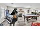 Stylish game room featuring a grand piano, fireplace, and a pool table for entertainment at 7141 Groveton Ct, Las Vegas, NV 89131