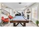 Entertaining game room with a pool table, fireplace, and piano, perfect for Gathering and friends at 7141 Groveton Ct, Las Vegas, NV 89131