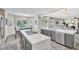 Modern kitchen boasts stainless steel appliances, gray cabinets, and an island with a cooktop at 7141 Groveton Ct, Las Vegas, NV 89131