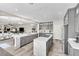 Open kitchen with an island, gray cabinets, stainless appliances, and seamless connection to living area at 7141 Groveton Ct, Las Vegas, NV 89131