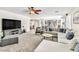 Spacious living room features a ceiling fan and flows into an open-concept kitchen with stainless steel appliances at 7141 Groveton Ct, Las Vegas, NV 89131