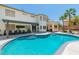 Backyard featuring a large pool, a covered patio with furniture, and well-maintained landscaping at 7141 Groveton Ct, Las Vegas, NV 89131
