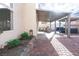 Spacious backyard patio with covered seating, outdoor kitchen, a hot tub, and tasteful landscaping at 760 Camino La Paz, Henderson, NV 89012