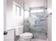 Modern bathroom featuring a glass shower with marble tile and stone pebble flooring at 760 Camino La Paz, Henderson, NV 89012