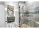 Modern bathroom features an upgraded shower and vanity, stone accents, glass shower door, and tiled floor at 760 Camino La Paz, Henderson, NV 89012