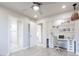 Bright bedroom featuring a built-in desk, multiple doors and gray wood-look flooring at 760 Camino La Paz, Henderson, NV 89012