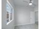 Bright bedroom with ceiling fan features wood-look flooring, neutral paint and view to the backyard at 760 Camino La Paz, Henderson, NV 89012