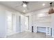 Bright bedroom with ceiling fan, built-in shelves and desk, and entrances to bathroom and walk-in closet at 760 Camino La Paz, Henderson, NV 89012