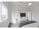Well-lit bedroom showcasing gray wood-look flooring, neutral walls, and ceiling fan at 760 Camino La Paz, Henderson, NV 89012