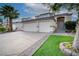 Charming stucco home featuring a three-car garage, desert landscaping, and covered front entry at 760 Camino La Paz, Henderson, NV 89012