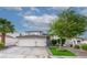 Charming home with a two-car garage, lush landscaping, and brick-lined driveway, creating curb appeal at 760 Camino La Paz, Henderson, NV 89012