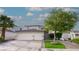 Charming home with a two-car garage, lush landscaping, and brick-lined driveway, creating curb appeal at 760 Camino La Paz, Henderson, NV 89012