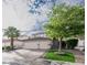 Charming stucco home featuring a three-car garage, desert landscaping, and covered front entry at 760 Camino La Paz, Henderson, NV 89012