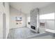 Bright living room with a modern fireplace, high ceilings, large windows, and stylish gray wood flooring at 760 Camino La Paz, Henderson, NV 89012