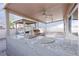 Outdoor kitchen with granite countertop and built-in grill under a covered patio with ceiling fans at 760 Camino La Paz, Henderson, NV 89012