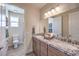 Bathroom with double sinks, granite countertops, and a separate toilet room at 7665 Serenity Bay Ln # Lot 58, North Las Vegas, NV 89084