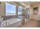 Bright bathroom featuring a soaking tub, separate glass shower, and granite countertops at 7665 Serenity Bay Ln # Lot 58, North Las Vegas, NV 89084