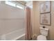 Bright bathroom featuring a tub/shower combination with white tile and modern art at 7665 Serenity Bay Ln # Lot 58, North Las Vegas, NV 89084