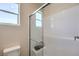 Bathroom featuring a modern shower with glass doors and white subway tile at 7665 Serenity Bay Ln # Lot 58, North Las Vegas, NV 89084