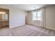 Carpeted bedroom that provides an ensuite bathroom, a window, and neutral paint at 7665 Serenity Bay Ln # Lot 58, North Las Vegas, NV 89084