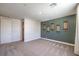 Carpeted bedroom featuring skateboards hanging on the wall at 7665 Serenity Bay Ln # Lot 58, North Las Vegas, NV 89084