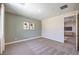 A bright bedroom features plush carpeting and two stylish paintings on the accent wall at 7665 Serenity Bay Ln # Lot 58, North Las Vegas, NV 89084