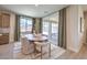 Dining area with a modern light fixture, a view of the backyard and sliding glass doors at 7665 Serenity Bay Ln # Lot 58, North Las Vegas, NV 89084