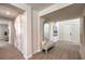 Bright entryway with a bench, decorative mirror, and gray wood-look flooring at 7665 Serenity Bay Ln # Lot 58, North Las Vegas, NV 89084