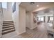 Open-concept view of the entryway with stairs and leading into the kitchen and living area at 7665 Serenity Bay Ln # Lot 58, North Las Vegas, NV 89084