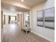 Spacious entryway with a bench, decorative mirror, and gray wood-look flooring at 7665 Serenity Bay Ln # Lot 58, North Las Vegas, NV 89084