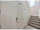 Hallway featuring a staircase with carpeted steps and white doors at 7665 Serenity Bay Ln # Lot 58, North Las Vegas, NV 89084